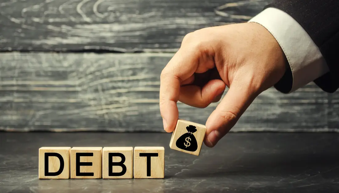 Wooden blocks spelling debt