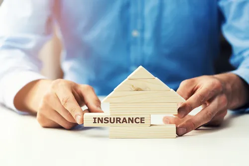 Wooden blocks shaped as a house with one marked insurance