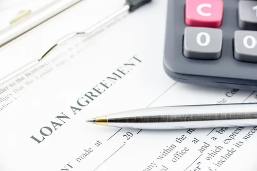 Loan agreement with a pen and a calculator
