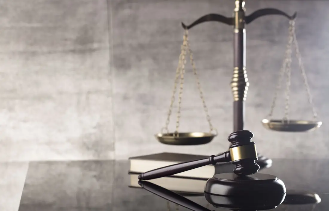 Scales of justice and a gavel on law books