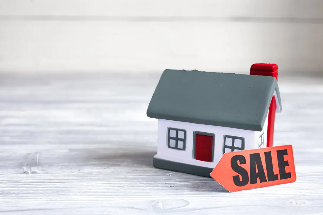 Model house with a sale tag